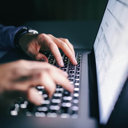 person typing on keyboard